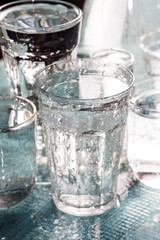 Glasses full of water for the refreshment on a hot summer day. Rain water on a table