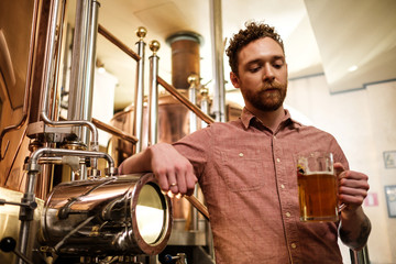 Man tasting fresh beer in a brewery