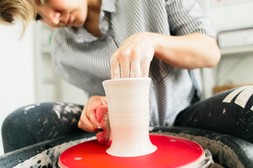 Women working on the potter's wheel in the studio