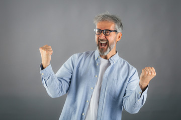 happy middle aged man on gray background