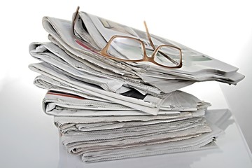 news paper with glasses with white background stock photo