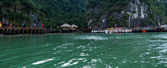 Halong bay islands sea landscape colorful cave attracting tourists.