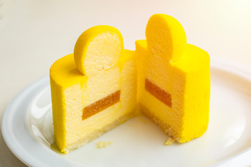 Cream cheesecake with mango and passion fruit. Cut a minicort on a plate_2