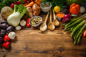 Assortment of fresh vegetables on wooden background