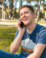 Teenager smiling talking on mobile phone.
