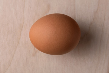 Lonely chicken egg on a wooden background