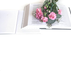 Flat lay: Bible and pink, red, rose flower bouquet. On white background. Baselland, Switzerland 12.05.2019