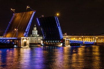 Fototapeta na wymiar St. Petersburg, - Opening of the Palace Bridge in St. Petersburg. View of the Kunstkammer over the bridge, Russia. drawbridges