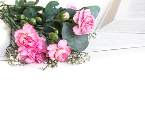 Flat lay: Bible and pink, red, rose flower bouquet. On white background. Baselland, Switzerland 12.05.2019