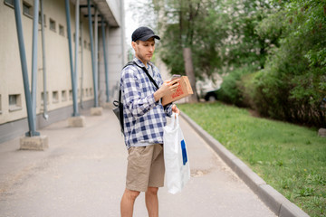 courier using a phone to searching the address path to deliver a packages