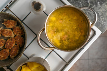 top view of boiling hot steaming soup with vegetables and meat, food preparation before a dinners