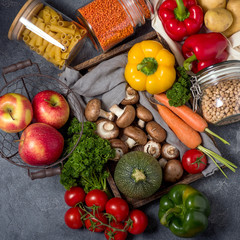 Groceries from farmer's market, healthy organic vegetables and fruits  in reusable cotton bag and glass jars, eco-friendly lifestyle and shopping, zero waste