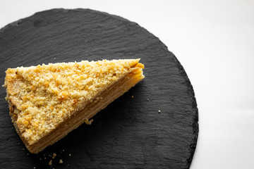 a piece of honey cake on a stone plate