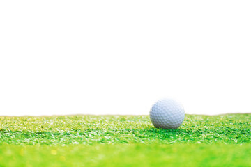 Golf balls on green grass isolated from a white background