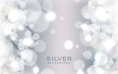 Silver abstract bokeh background sparkling lights effect. Blured circle on gray background.