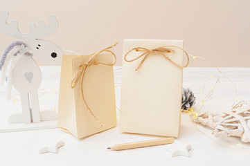 mockup of two Christmas kraft gift packages with tag on wooden background. Top view for greeting card