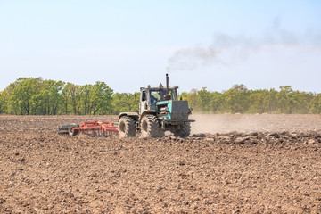 Fototapeta premium The tractor plows the soil.