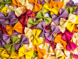 Italian colored dried farfalle pasta, a background pattern