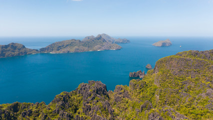 Fototapeta na wymiar Seascape with tropical islands. El Nido Palawan National Park Philippines. Rocky islands covered with forest. Small lagoons with white beaches. Boat tours between the islands.