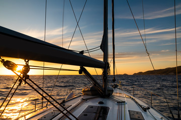 Yacht sailing at sunset during a storm. Luxury vacation at sea