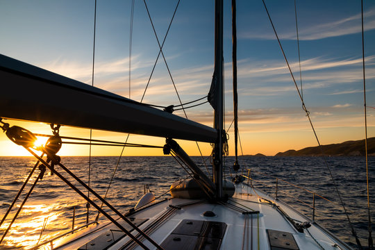 Yacht Sailing At Sunset During A Storm. Luxury Vacation At Sea