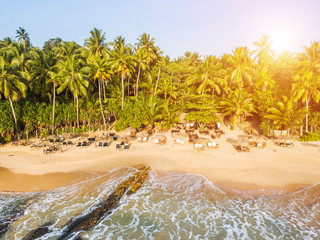 Sunset on a tropical beach with palm trees
