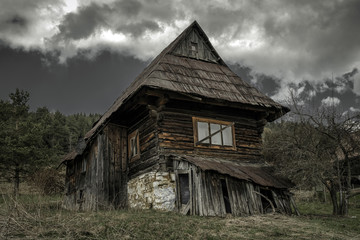 Old cottage and dark clouds