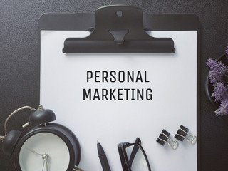 Business or Job Hiring concept - Top view of a clipboard and white sheet with PERSONAL MARKETING  written on it.
