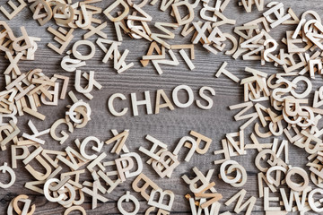 some wooden letters and the word chaos