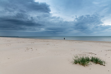 Walker at Baltic sea in cloudy day.