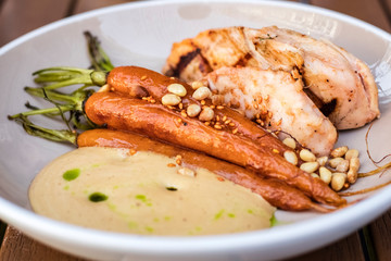 delicious dish of fried chicken and braised carrots with pine nuts. Cream sauce