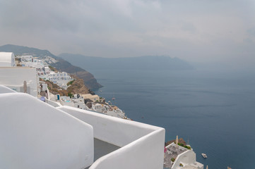 Panorama of Oia white houses with caldera immersed in the mist