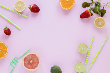 Frame of citrus fruits and strawberries