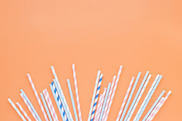 Different plastic straws on table