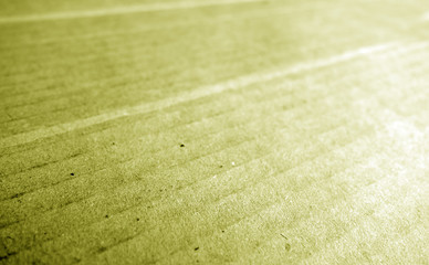Cardboard close-up with blur effect in yellow tone.