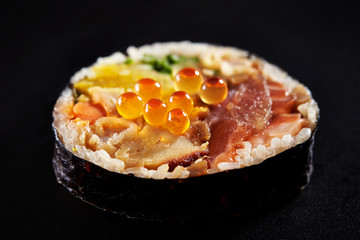 Japanese sushi roll on black background 