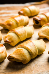 Freshly baked french pastry croissants or rolls on baking tray