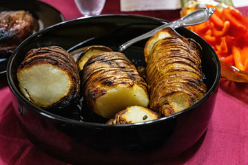 bowl of sliced russet potatoes on the table t ready for dinner