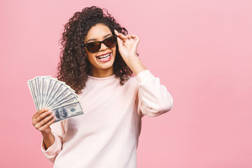 Cool rich girl! Money winner! Surprised beautiful african american woman in casual holding money in...