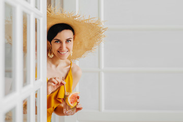 Young woman in straw hat with a cocktail. Summer Vacation concept