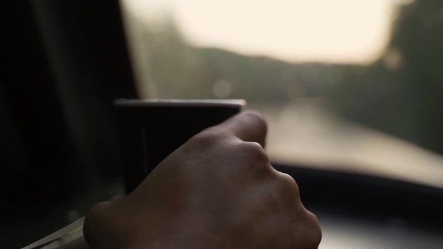Someone holding a cup of coffee in front of a train window in movement - slow motion.