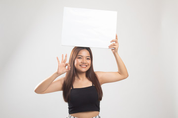 Young Asian woman show OK with  white blank sign.