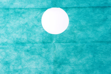 Sterile green gauze with hole for surgeries. Green gauze background