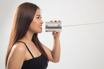 Young Asian woman with tin can phone.
