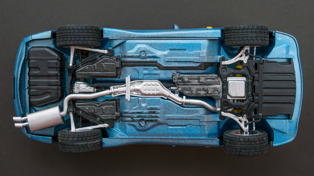 inverted car on a black background. bottom view of car