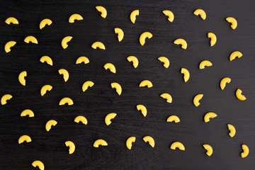Pattern of A pile of pasta horns on black background