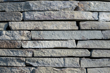 Masonry gray stone without mortar background and texture