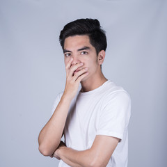 Fototapeta na wymiar Portrait handsome young asian man wearing a white T-shirt stressed and anxiety isolated on grey background. Asian man people. business success concept.