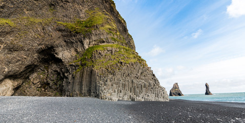 Black Beach in Iceland - Panormic shot Of Reynisdrangar - columar basalt at the ring road in the south of Iceland