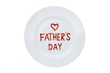 Father's Day is written in red ketchup on a white plate. View from above
